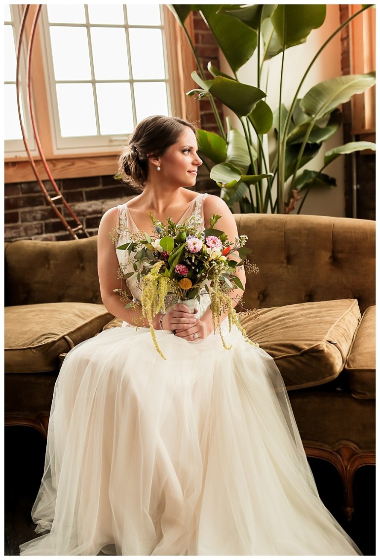 portrait of bride looking over shoulder and bouquet
