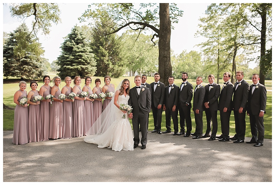 bride groom and wedding party smiling