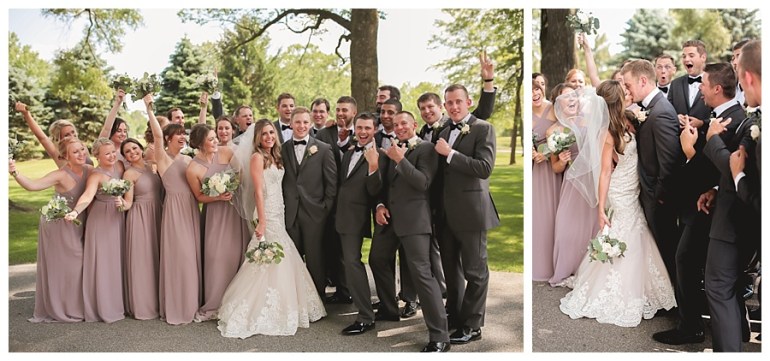 bride and groom with wedding party excited and kissing