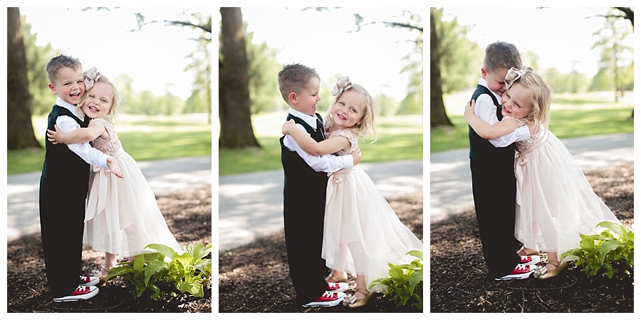 flower girl and ring bearer hugging laughing smiling